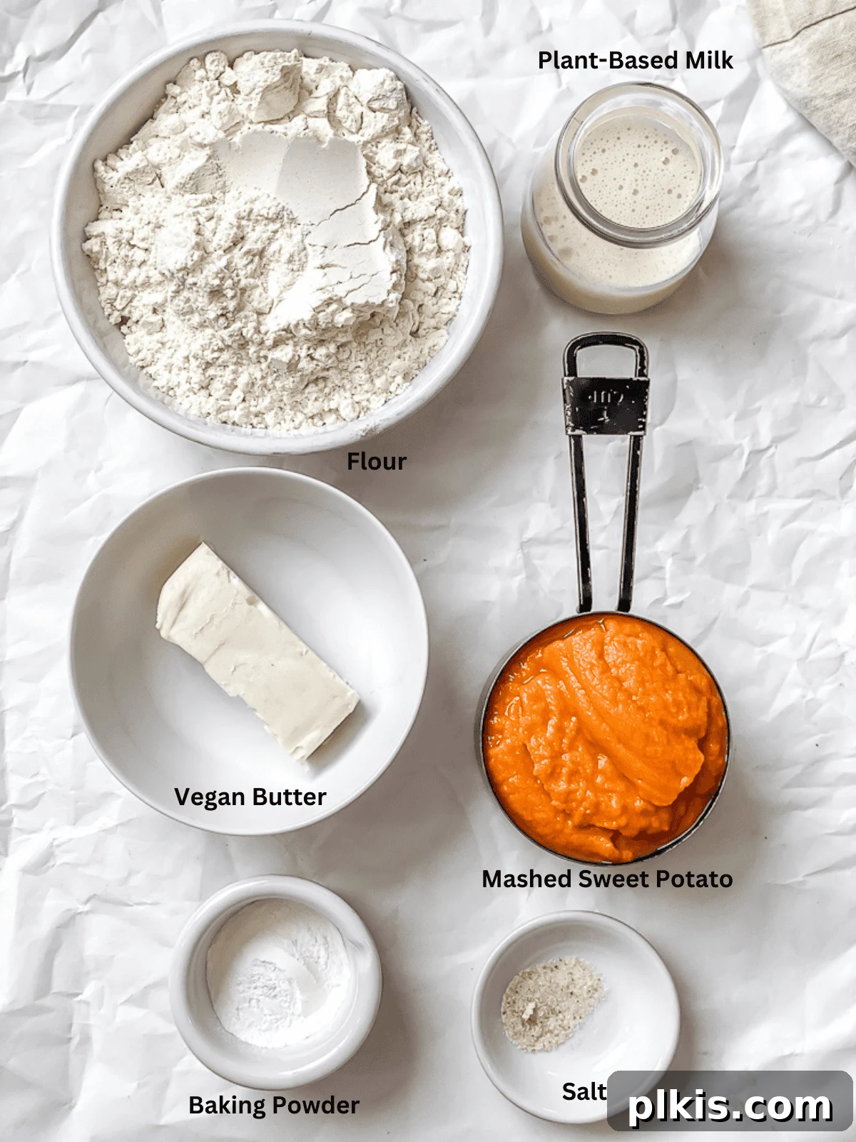 Velvet Sweet Potato Biscuits 3 A display of fresh ingredients for sweet potato biscuits, including sweet potato puree, flour, vegan butter, and plant milk.