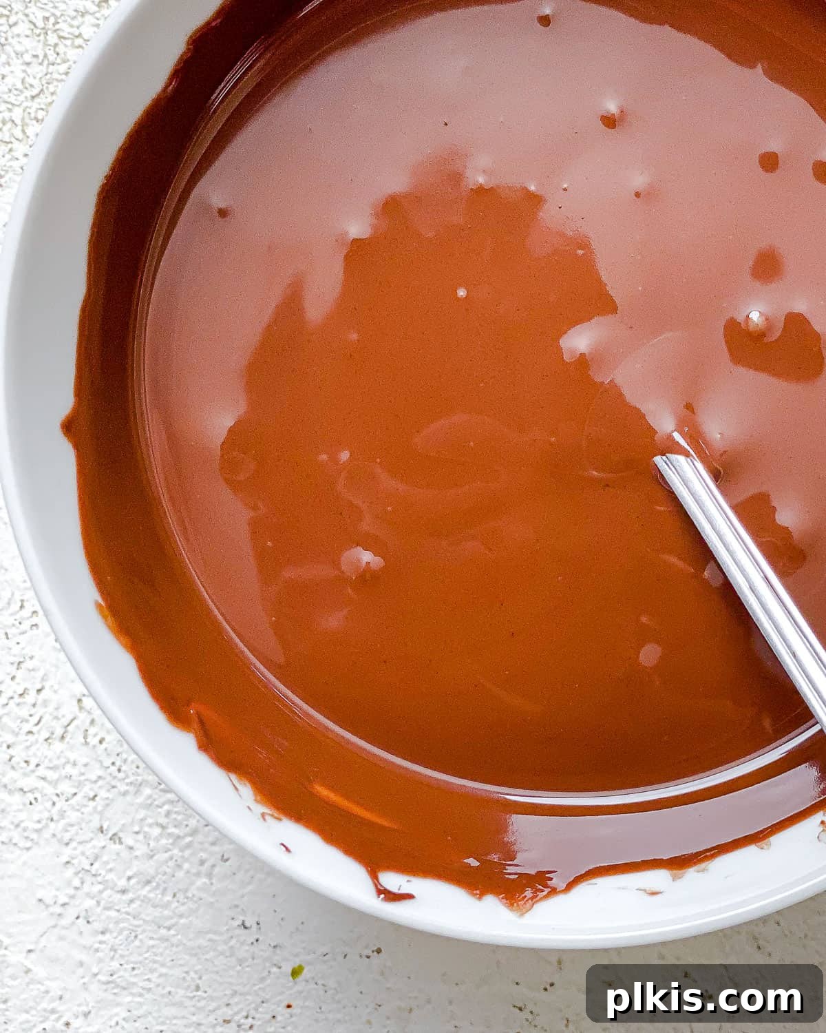 Irresistible Chocolate Chickpea Bites 6 Smooth, melted vegan chocolate in a bowl, ready to coat the crispy chickpeas.