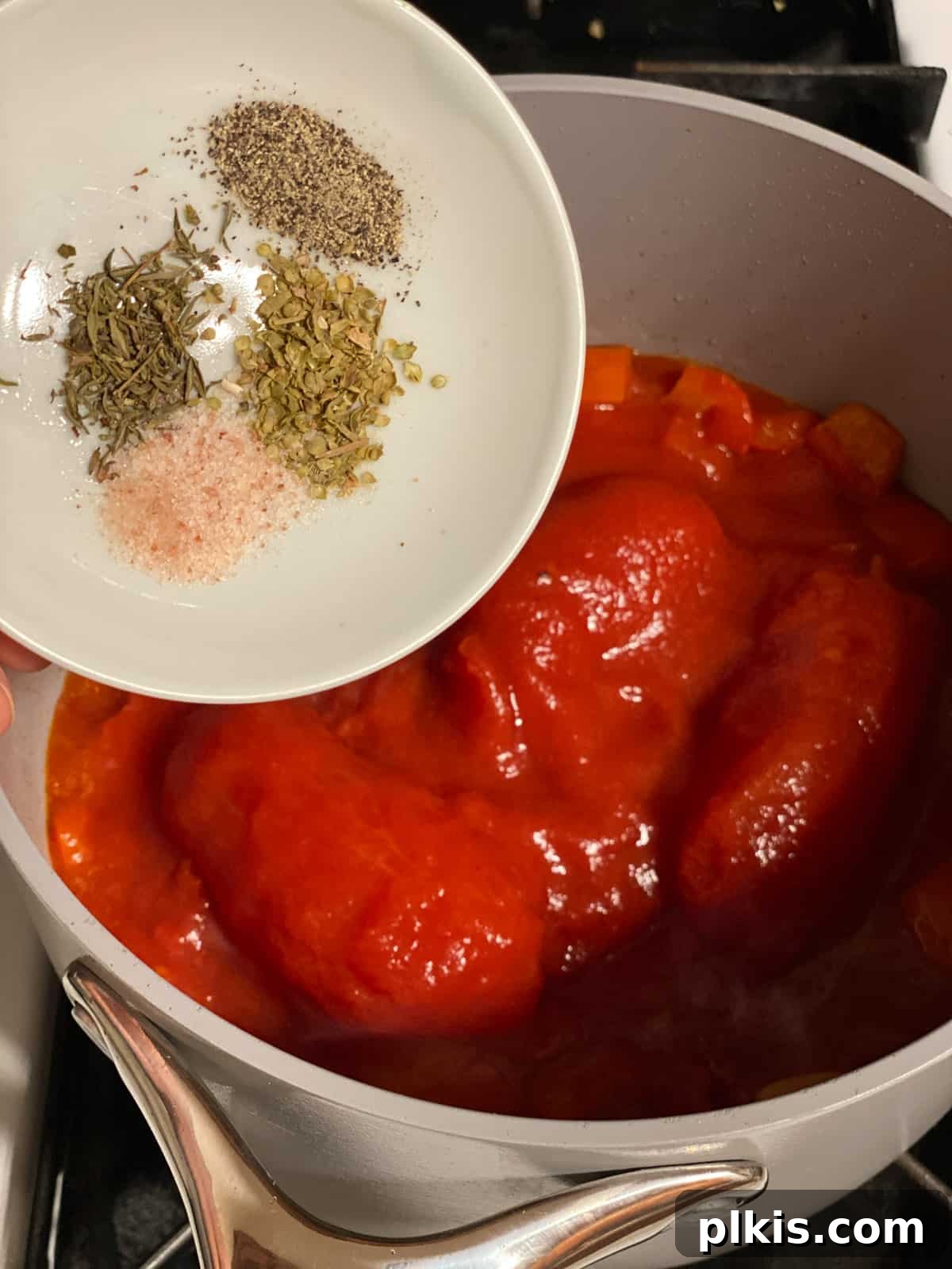 Pantry-Friendly Vegan Tomato Soup 7 Process shot of adding dried spices to the simmering tomatoes.