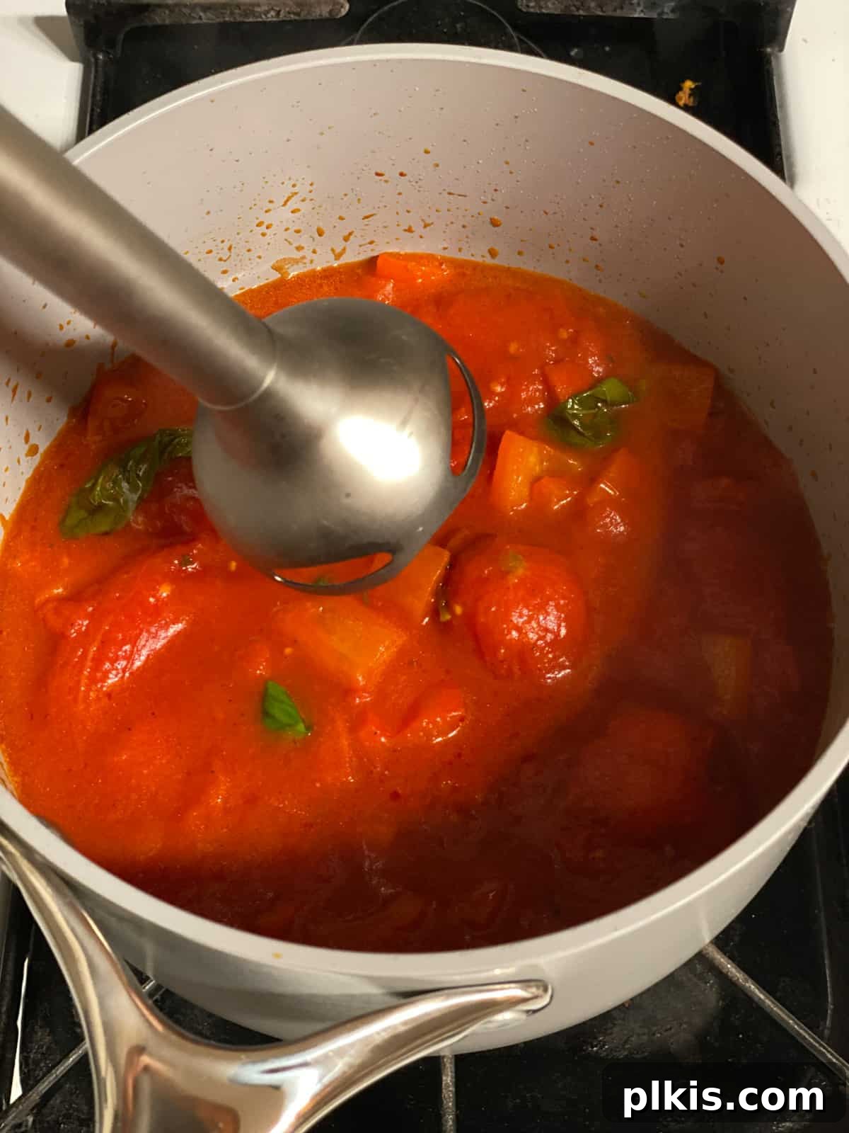 Pantry-Friendly Vegan Tomato Soup 9 Process shot of using an immersion blender directly in the pot to purée the soup.