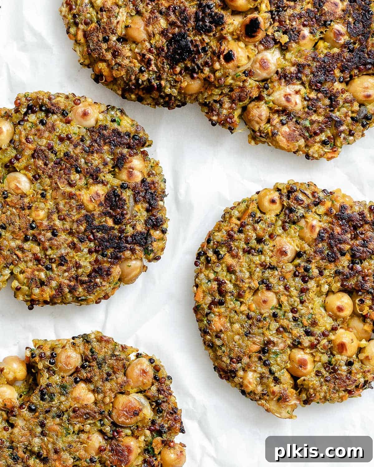 Golden Quinoa Chickpea Fritters 11 completed Quinoa Chickpea Patties on a white surface