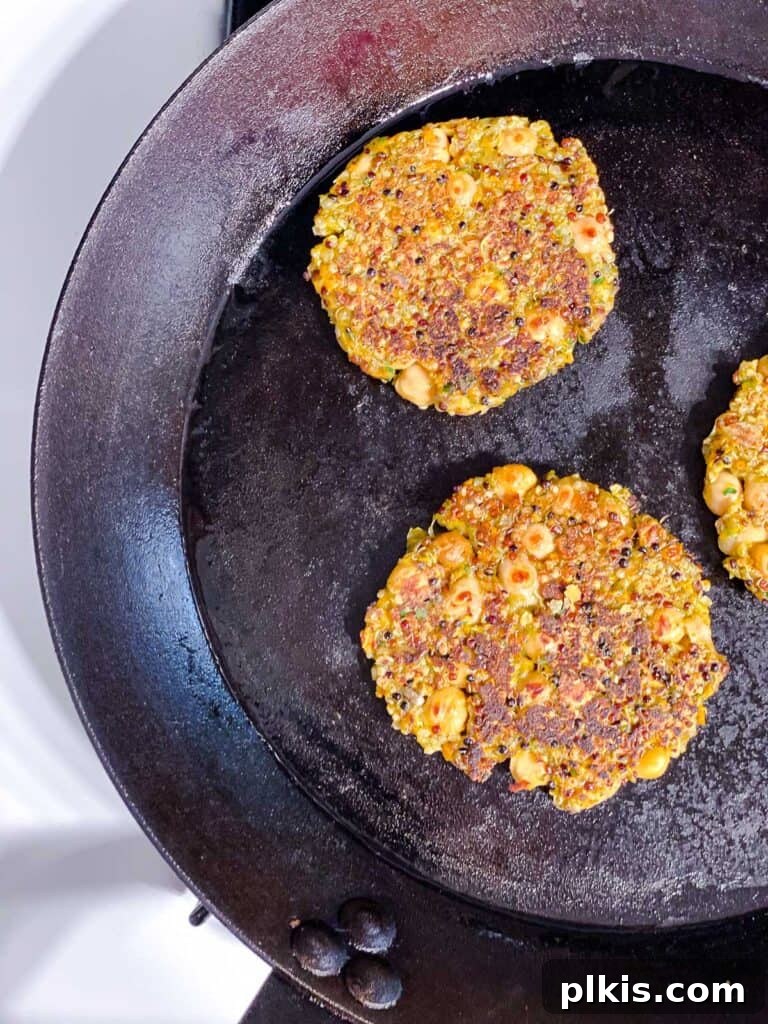 Golden Quinoa Chickpea Fritters 10 process shot of cooking patties on a skillet