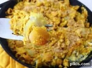 Loaded Potato Macaroni Casserole 2 Baked potato macaroni and cheese in a cast iron skillet.