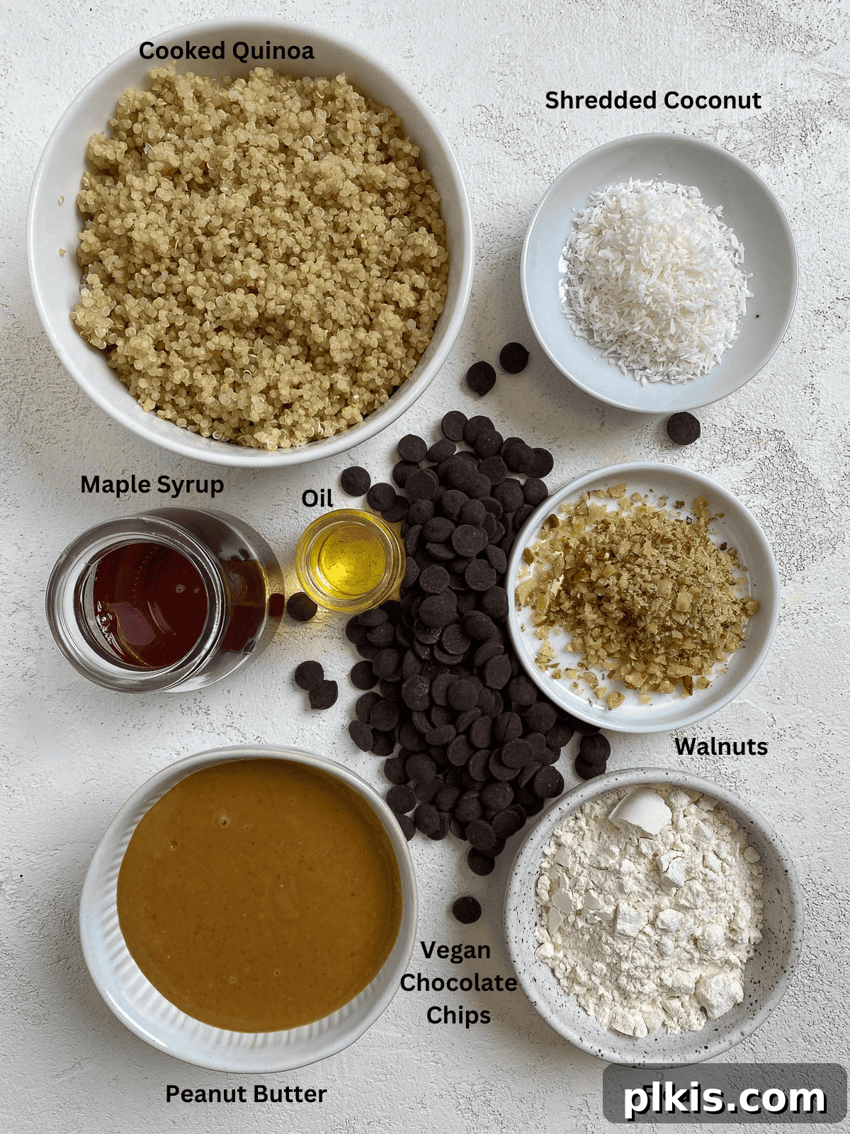 Plant-Powered Quinoa Chocolate Chip Cookies 3 A vibrant collection of raw ingredients for Vegan Chocolate Chip Quinoa Cookies laid out on a clean surface, showcasing fresh quinoa, nut butter, maple syrup, and chocolate chips.