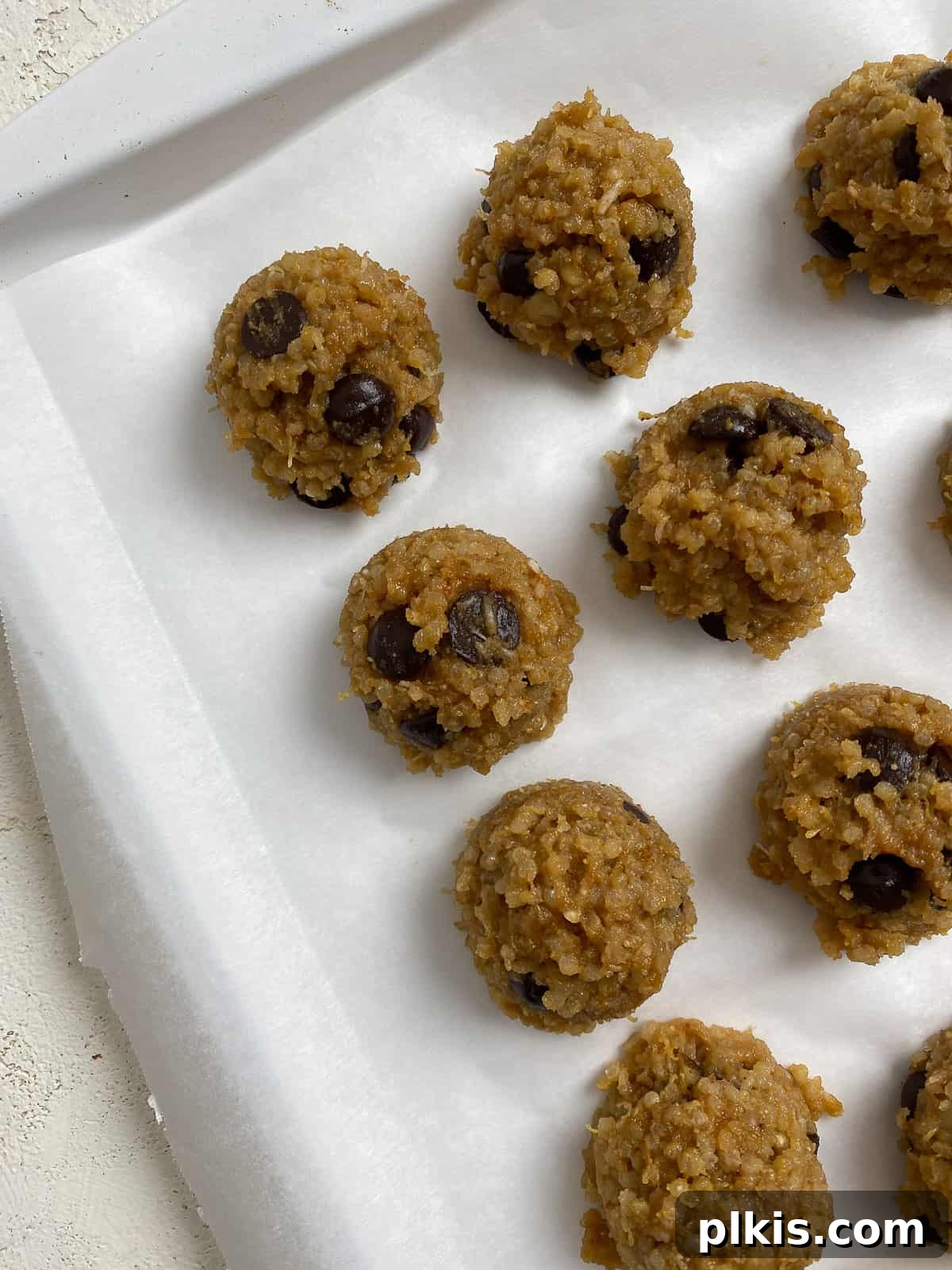 Plant-Powered Quinoa Chocolate Chip Cookies 5 A baking sheet lined with neatly scooped, pre-frozen Vegan Chocolate Chip Quinoa Cookies, ready for chilling to achieve their perfect no-bake texture.