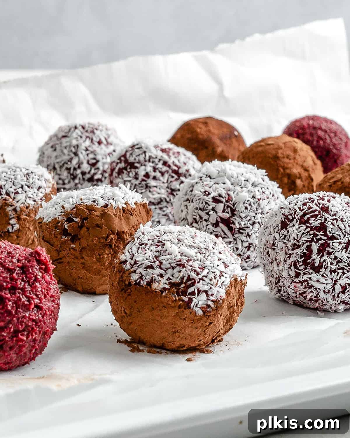 Vibrant Beet Power Bites 2 Completed beet energy balls neatly arranged on a pristine white surface, ready to be enjoyed as a healthy snack.