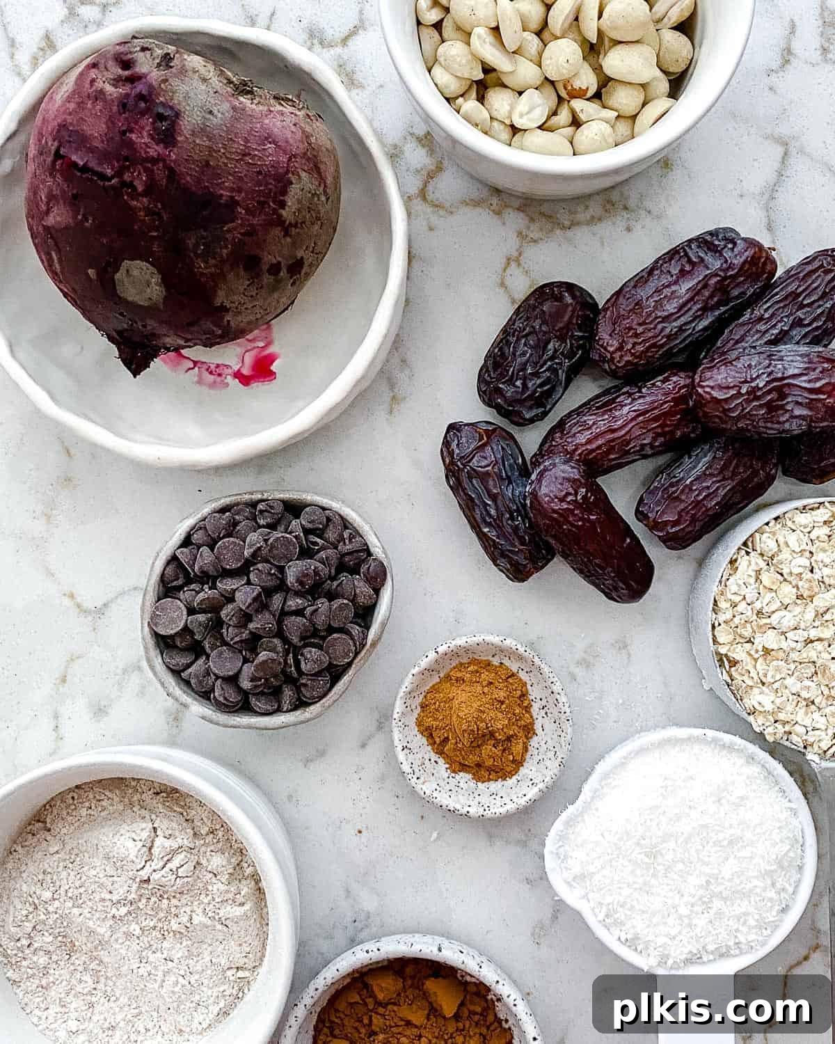 Vibrant Beet Power Bites 3 Ingredients for Beet Energy Balls are carefully measured out and arranged against a clean white surface, showcasing their natural colors and textures.