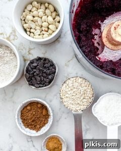 Ingredients for Beet Energy Balls, including vibrant beets, oats, and nuts, measured out and ready for blending.