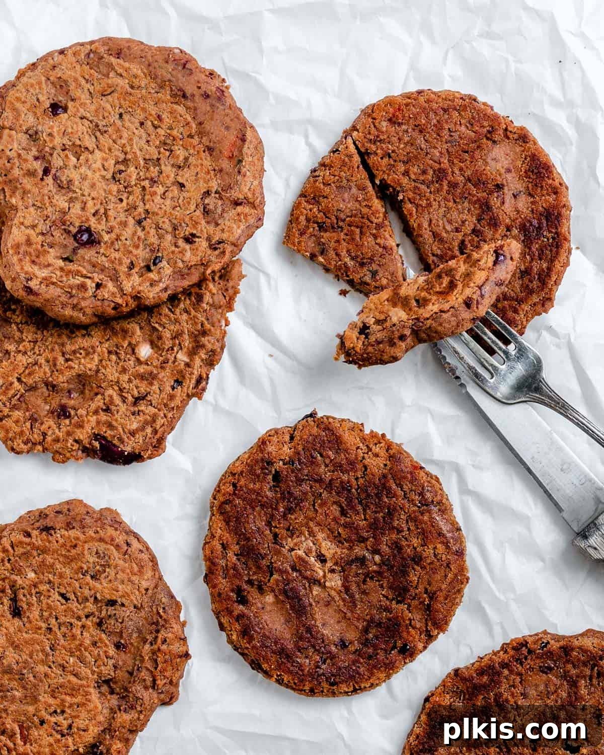 Quick-Fix 4-Ingredient Vegan Burgers 2 Delicious Easy Vegan Burgers laid out on a clean white surface, ready to be served
