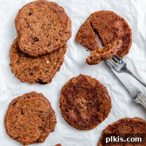 Quick-Fix 4-Ingredient Vegan Burgers 12 Completed Easy Vegan Burgers spread out on a white surface