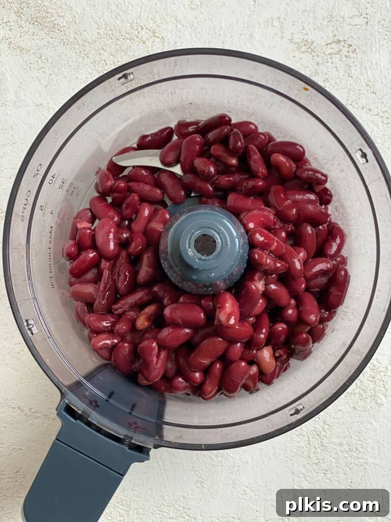 Quick-Fix 4-Ingredient Vegan Burgers 4 Process shot of adding kidney beans to a food processor