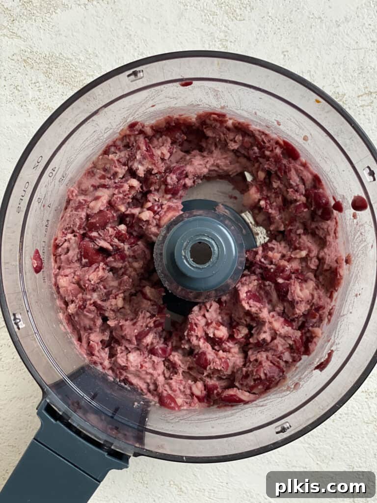 Quick-Fix 4-Ingredient Vegan Burgers 5 Process shot of kidney beans after being processed in a food processor, showing a smooth yet slightly chunky texture