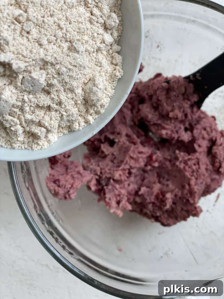 Quick-Fix 4-Ingredient Vegan Burgers 6 Process shot of adding oat flour to the bean mixture in a food processor