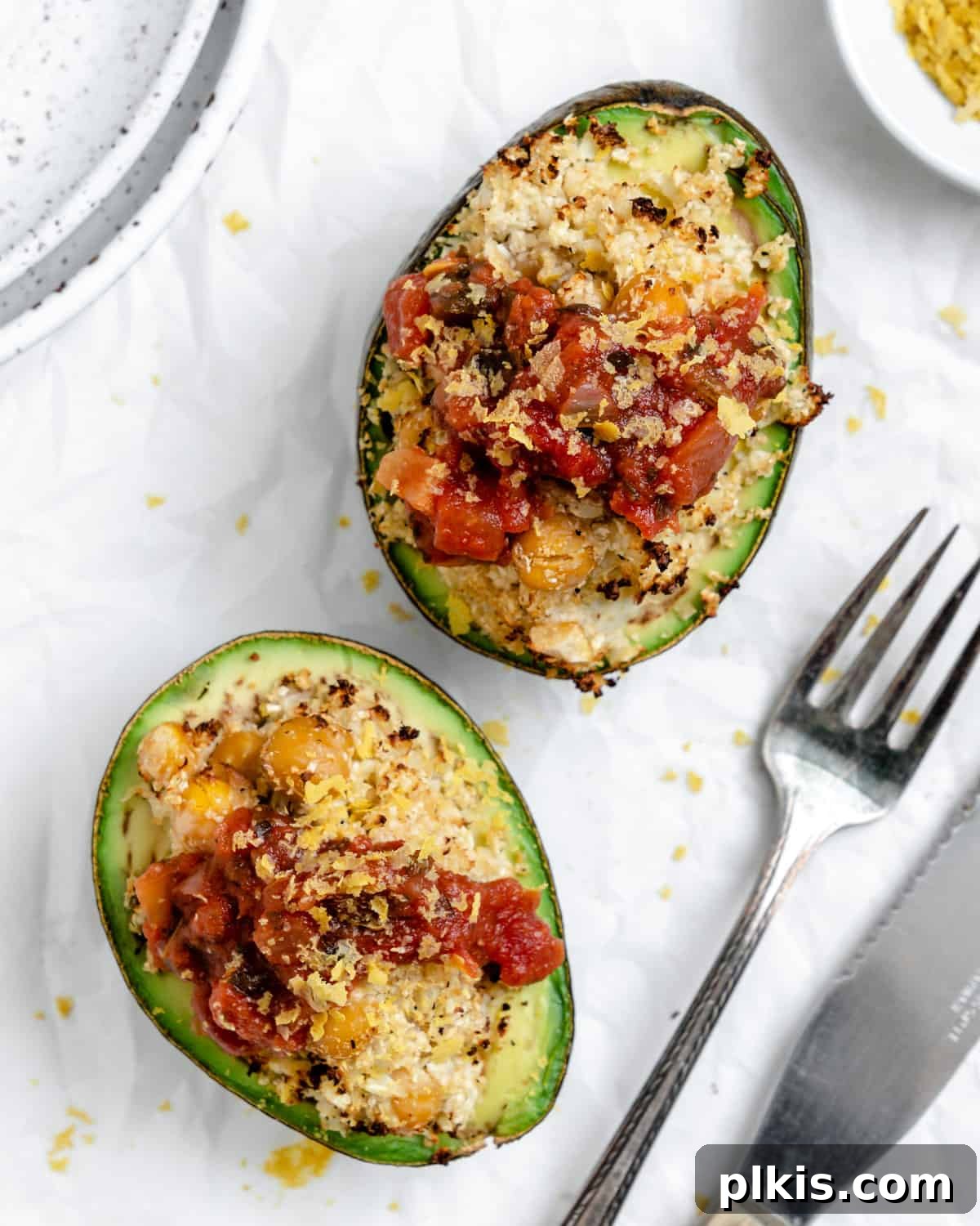 Nutrient-Packed Stuffed Avocado Delights 2 Delicious and healthy stuffed avocados with cauliflower rice and chickpeas, garnished and ready to eat.