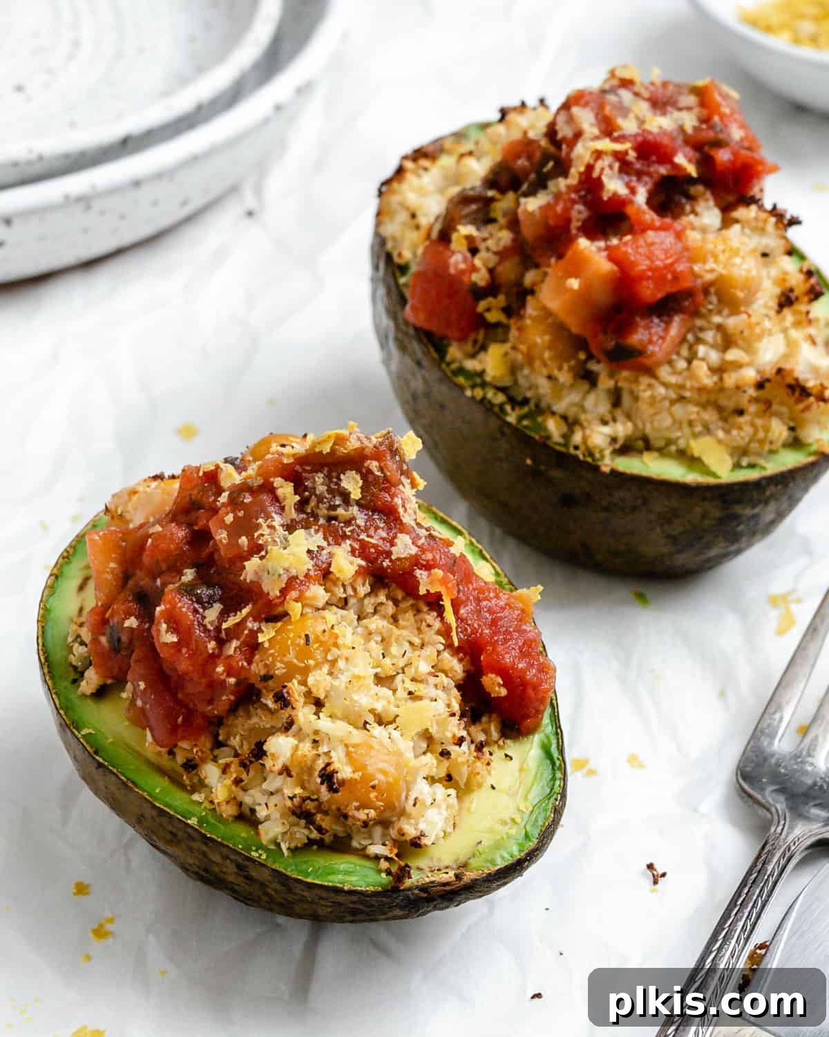 Nutrient-Packed Stuffed Avocado Delights 12 A beautifully presented healthy stuffed avocado dish on a white surface, ready to be enjoyed.