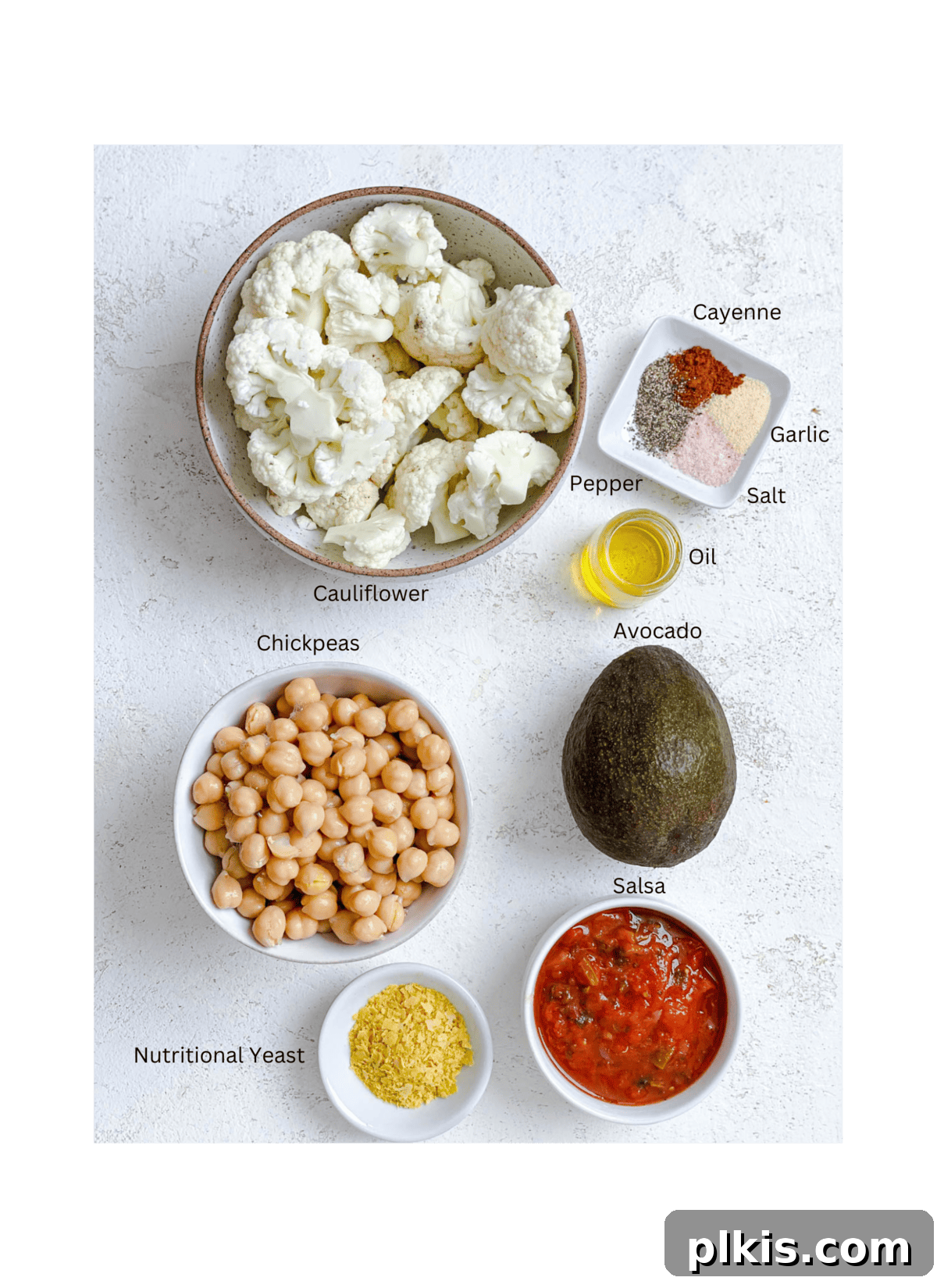 Nutrient-Packed Stuffed Avocado Delights 3 Arrangement of fresh ingredients for healthy stuffed avocados, including avocado halves, chickpeas, cauliflower rice, and spices.