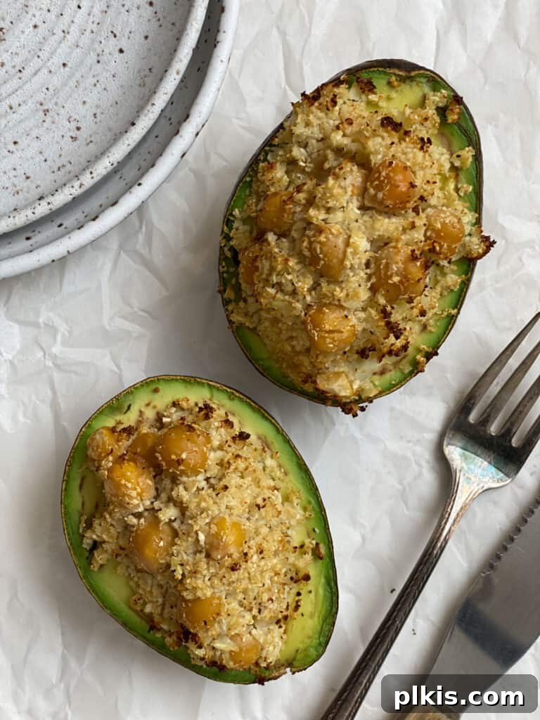Nutrient-Packed Stuffed Avocado Delights 10 Close-up of a completed healthy stuffed avocado on a white surface, garnished and ready to eat.