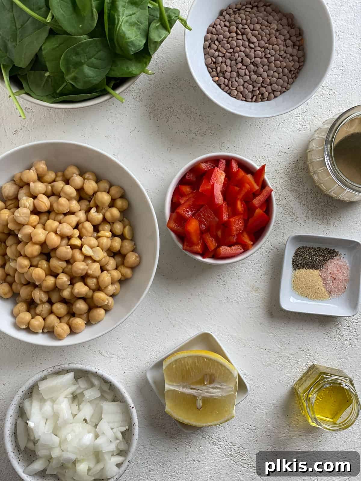 Fresh Lemon Herb Lentil Chickpea Salad 3 Ingredients for Vegan Lentil Chickpea Salad measured out and arranged on a white surface.