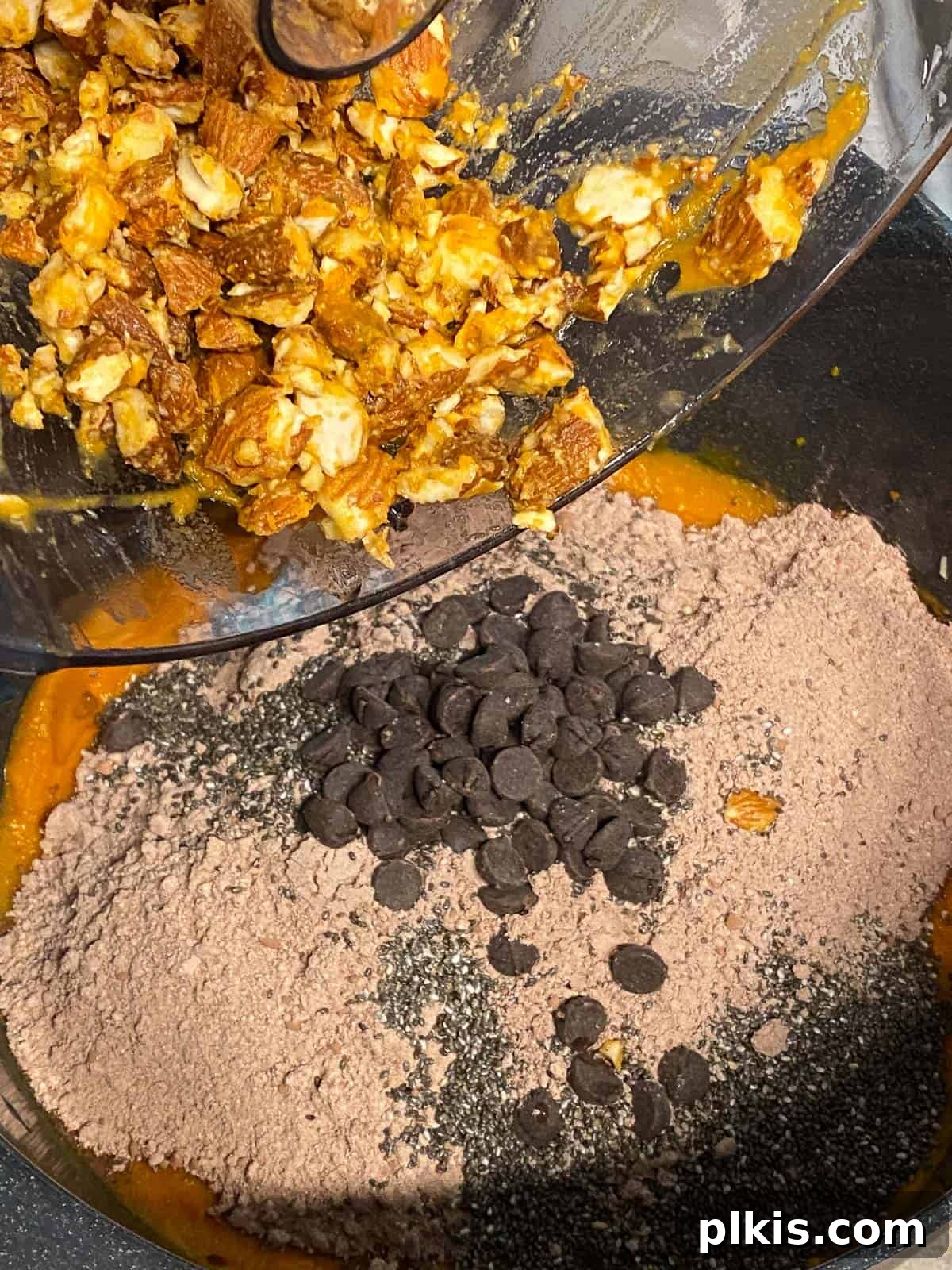 Decadent Sweet Potato Chocolate Cake 11 Process shot of adding crushed almonds to the sweet potato chocolate cake batter