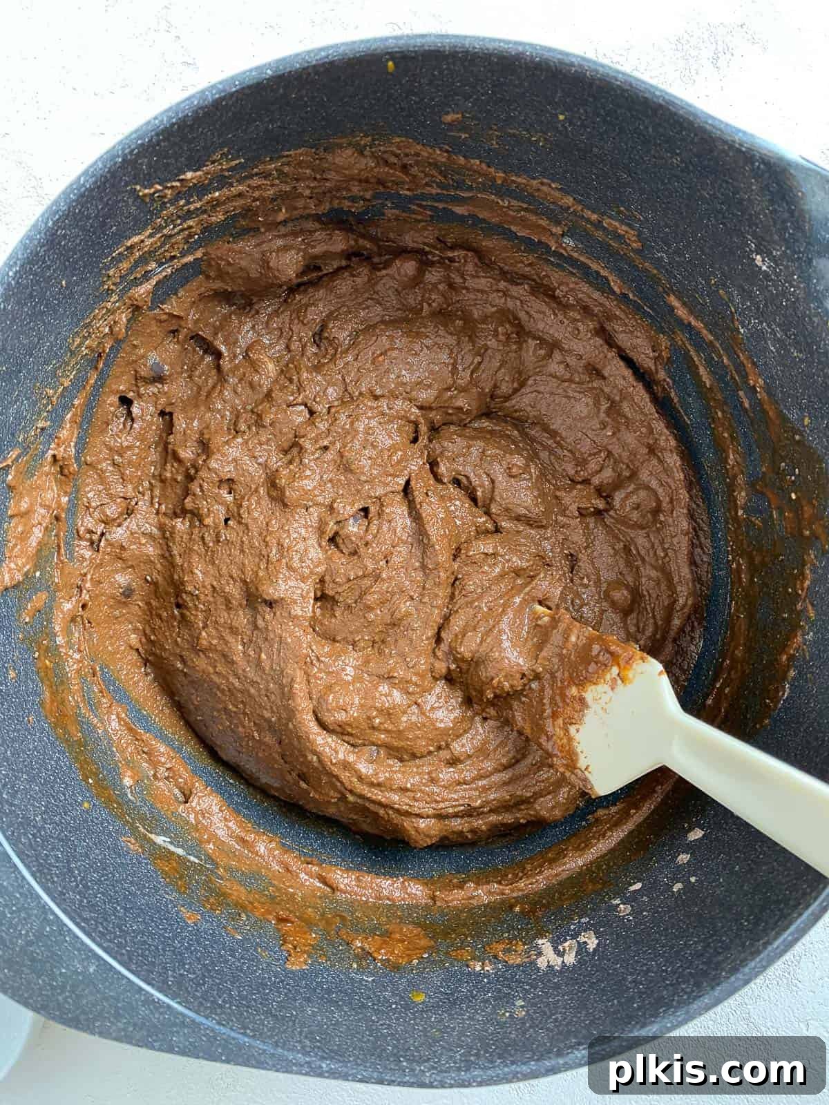 Decadent Sweet Potato Chocolate Cake 12 Process shot of the sweet potato chocolate cake mixture being mixed thoroughly in a bowl to form a dough