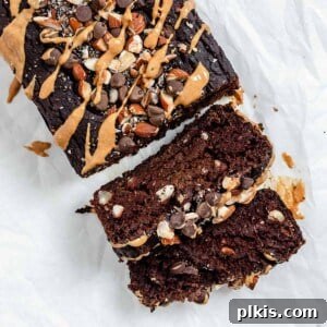 Completed Sweet Potato Chocolate Cake with two sliced pieces against a white surface