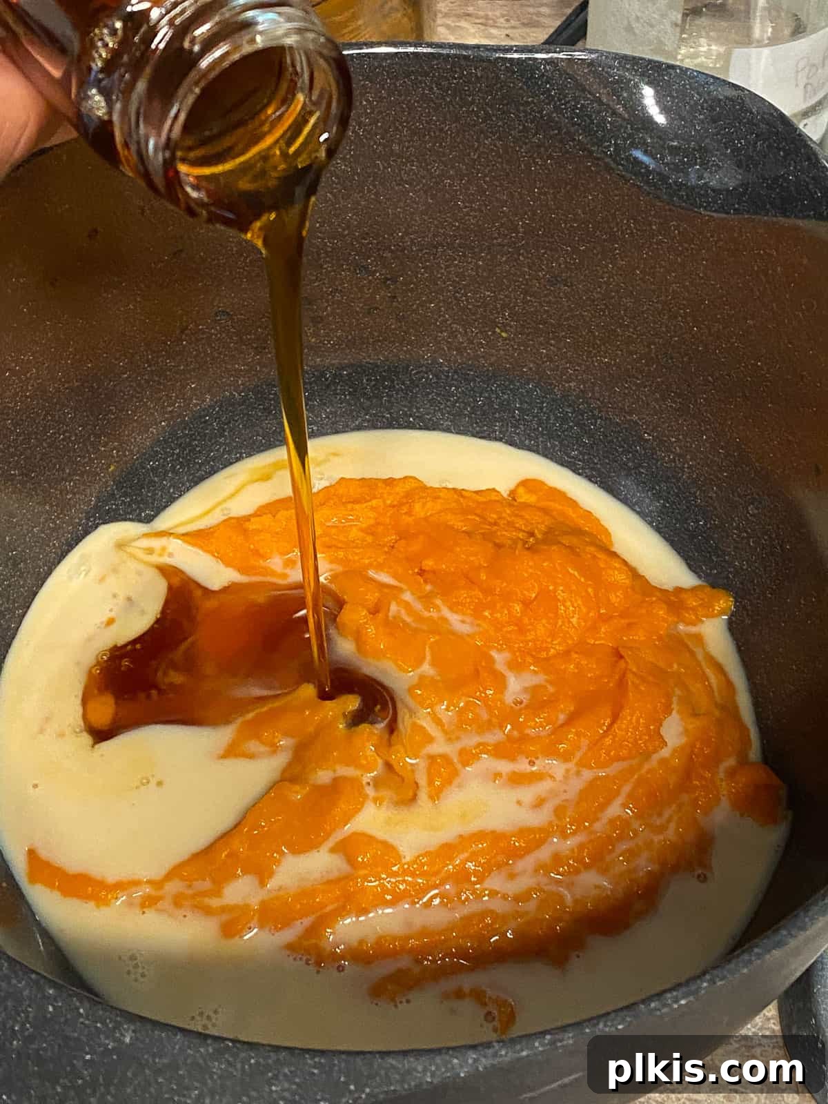 Decadent Sweet Potato Chocolate Cake 6 Process shot of adding maple syrup to the sweet potato and milk mixture