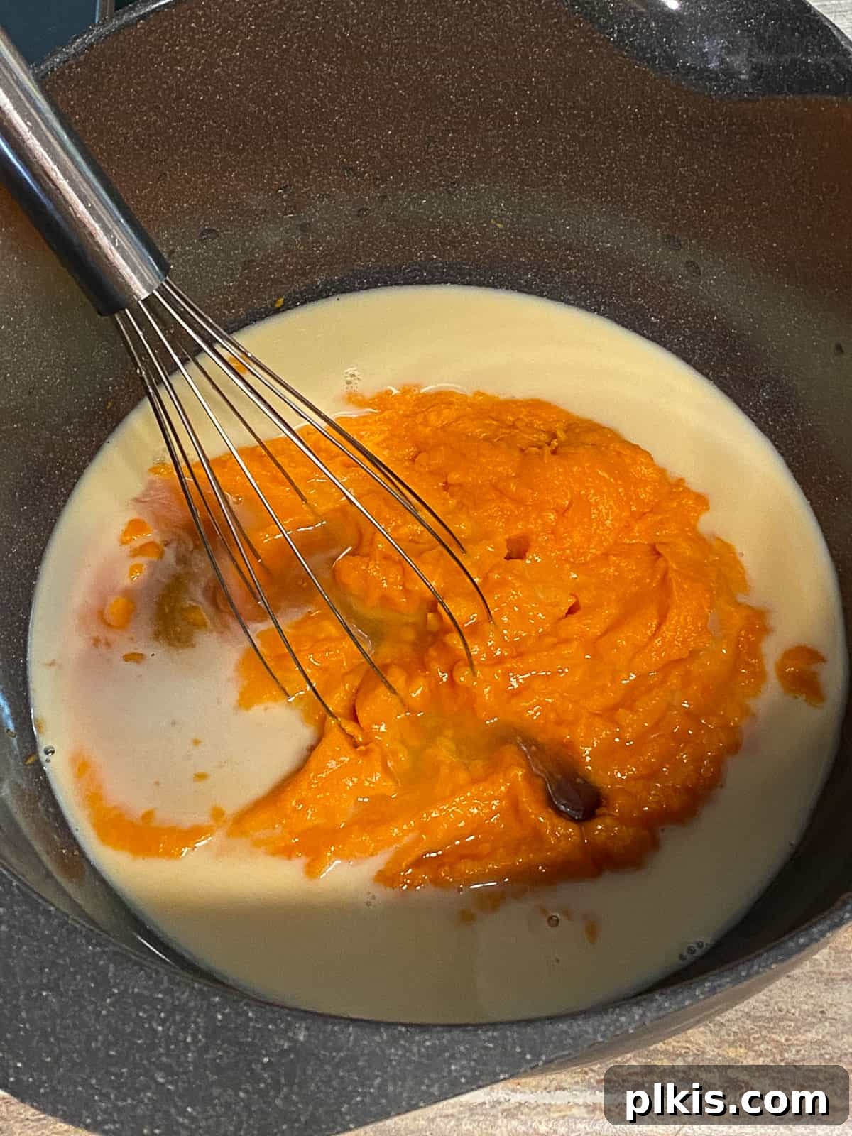 Decadent Sweet Potato Chocolate Cake 7 Process shot of whisking the sweet potato, milk, and maple syrup mixture in a bowl