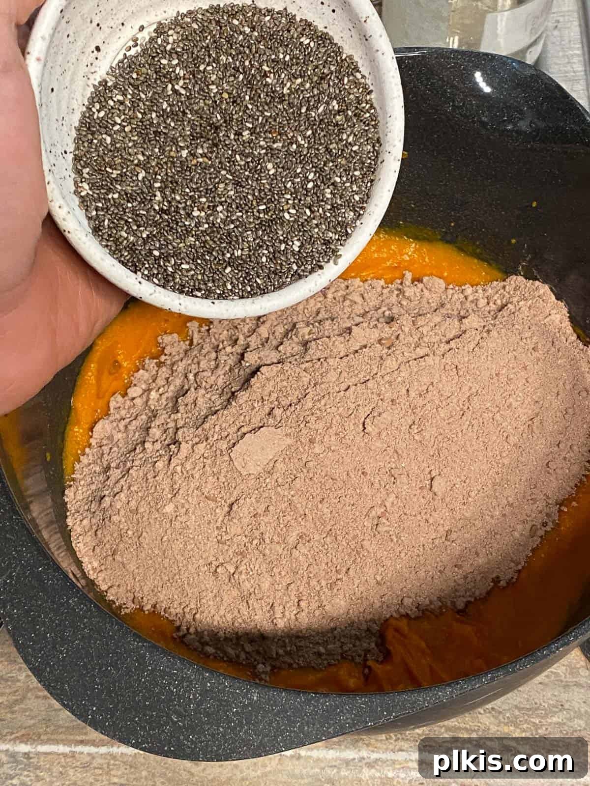 Decadent Sweet Potato Chocolate Cake 9 Process shot of adding chia seeds to the sweet potato chocolate cake batter