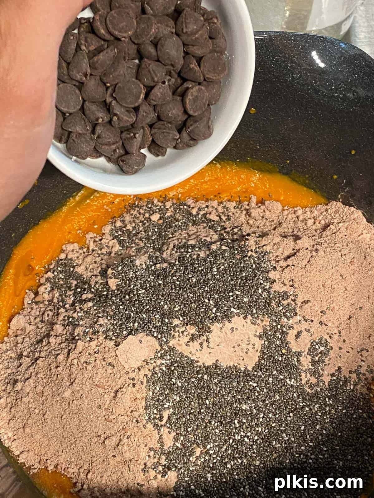 Decadent Sweet Potato Chocolate Cake 10 Process shot of adding vegan chocolate chips to the sweet potato chocolate cake batter