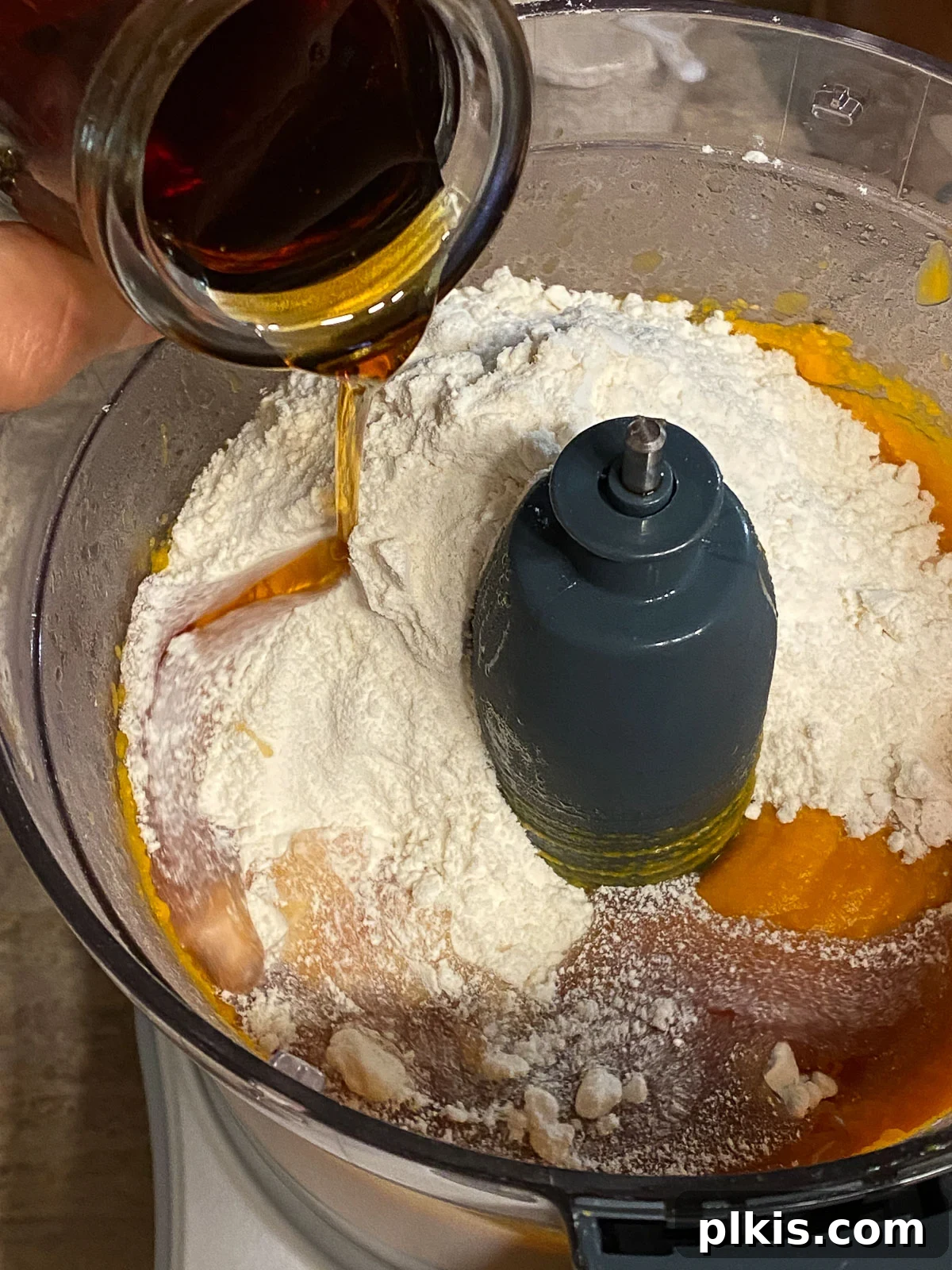 Decadent Vegan Sweet Potato Brownies 5 process of adding maple syrup to mixture in food processor