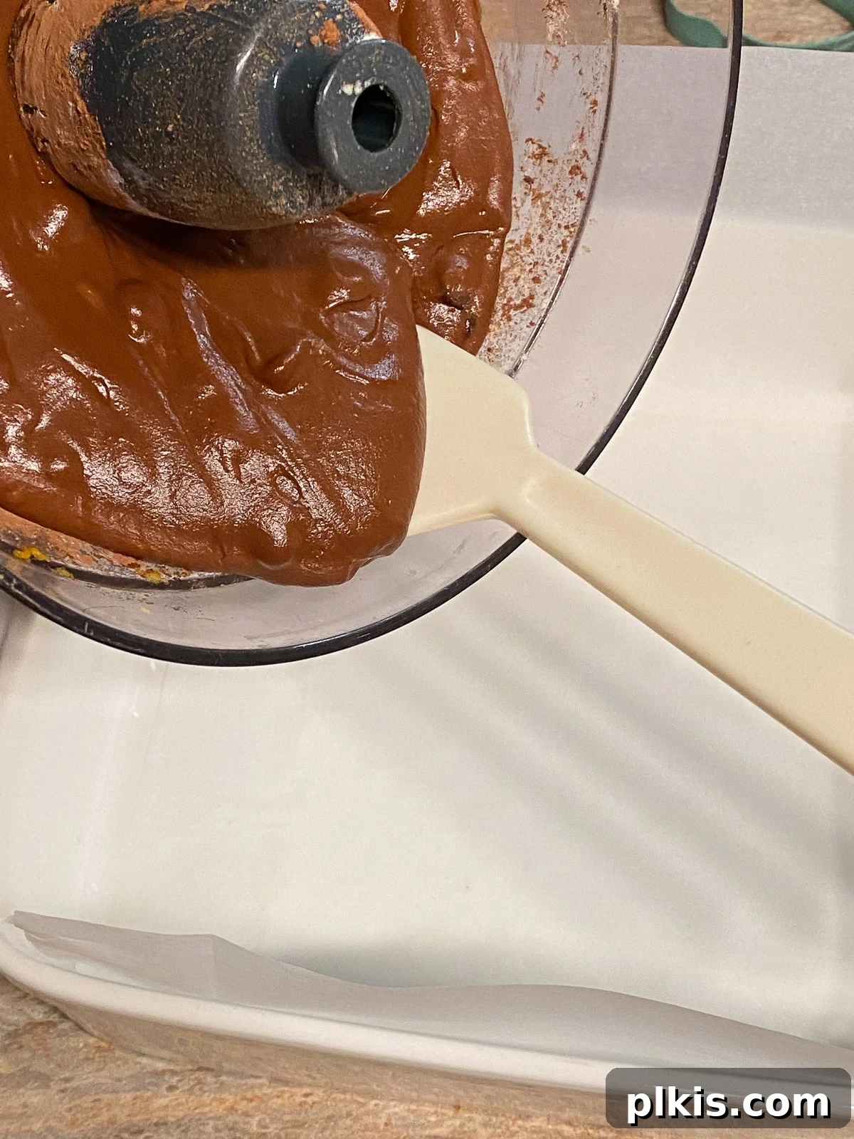Decadent Vegan Sweet Potato Brownies 10 process of pouring the sweet potato brownie mixture into white baking tray