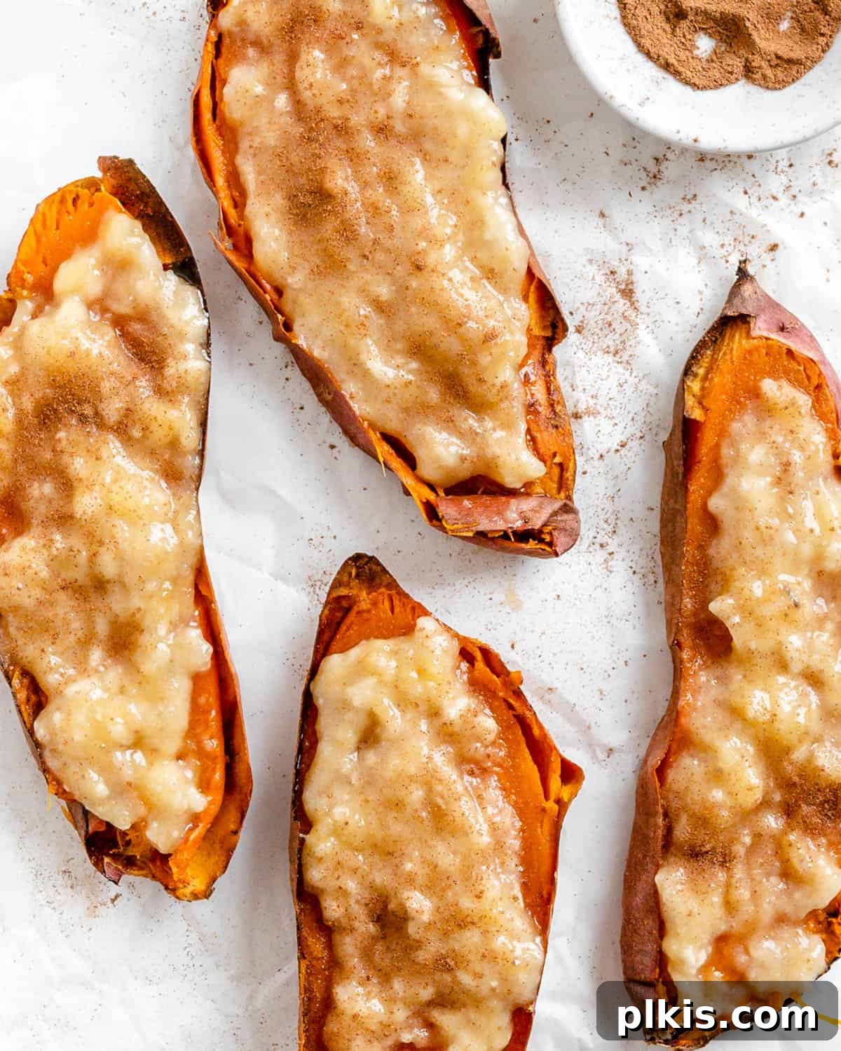 Sweet Potato Toast: Beyond Bread 2 Completed Easy Sweet Potato Toast pieces spread out on a white surface, garnished with mashed banana and a sprinkle of cinnamon.