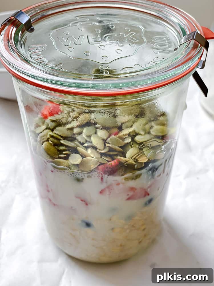 Vegan Overnight Oats: Endless Flavor Possibilities 5 Process shot showing ingredients being added into a glass jar for Vegan Overnight Oats