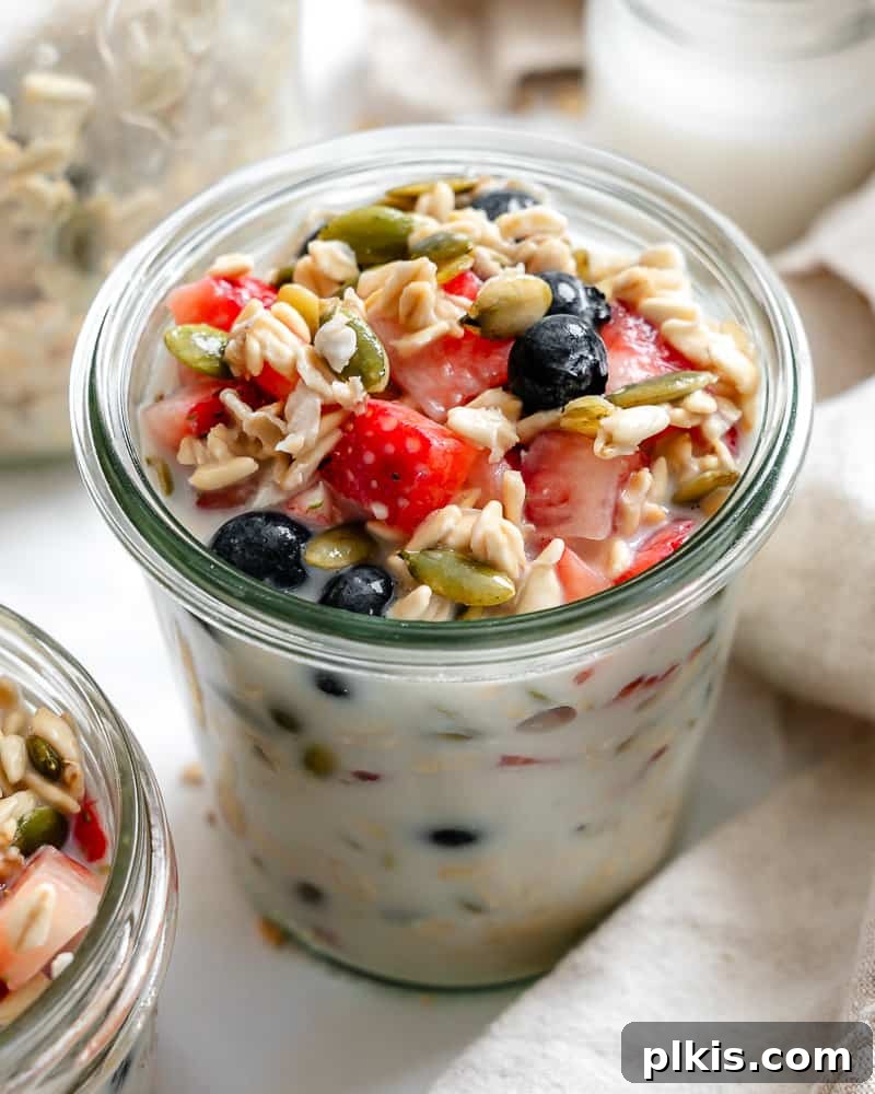 Vegan Overnight Oats: Endless Flavor Possibilities 6 Completed Vegan Overnight Oats in a glass jar, garnished with fresh berries and nuts
