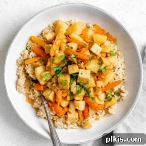 Creamy Red Curry Tofu: Slow Cooker or Stove Top 16 completed Slow Cooker Red Thai Curry with Tofu plated in a white dish against a white background