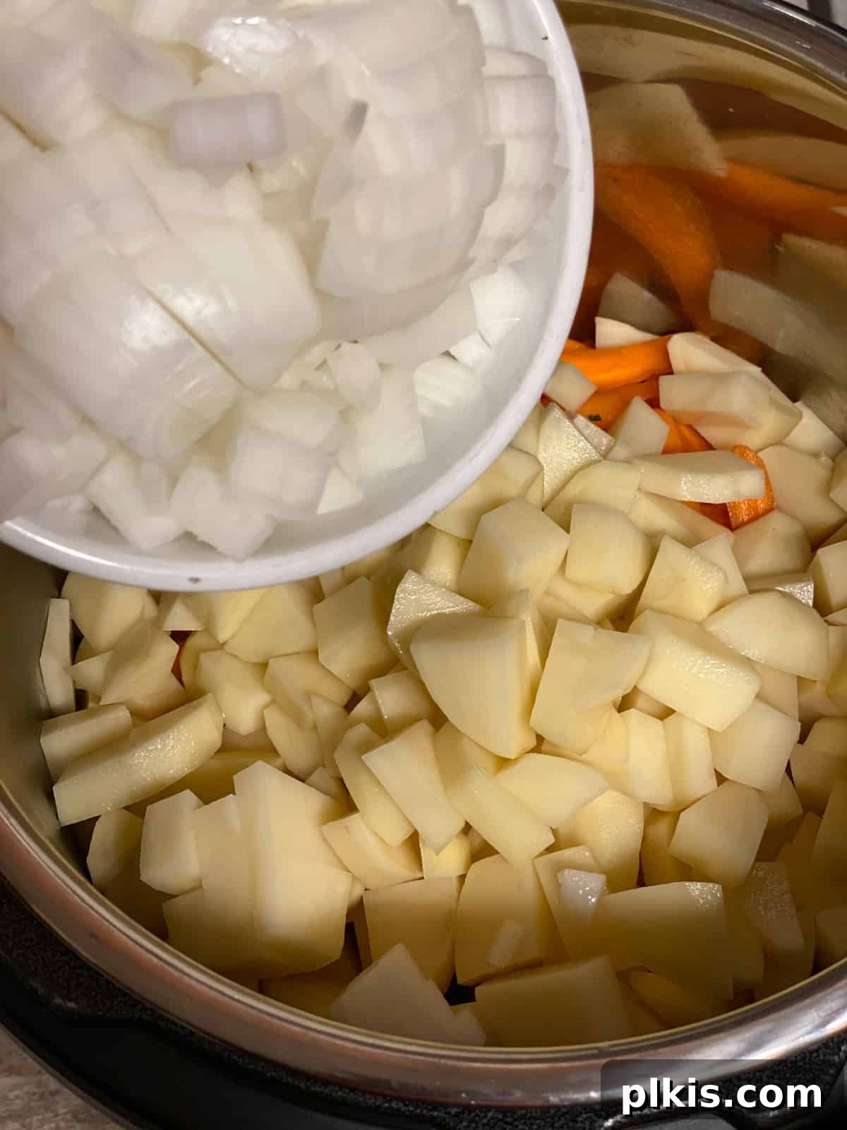 Creamy Red Curry Tofu: Slow Cooker or Stove Top 8 Diced onions being added to the pan, ready to contribute their aromatic base to the curry.