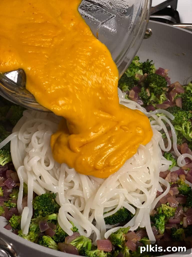 Golden Butternut Squash Sauce with Roasted Vegetables 13 process shot of adding sauce to pan
