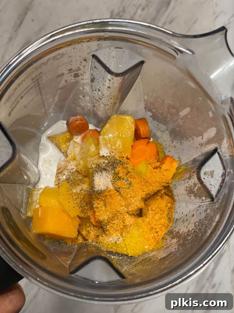 Golden Butternut Squash Sauce with Roasted Vegetables 5 process shot of adding veggies to blender