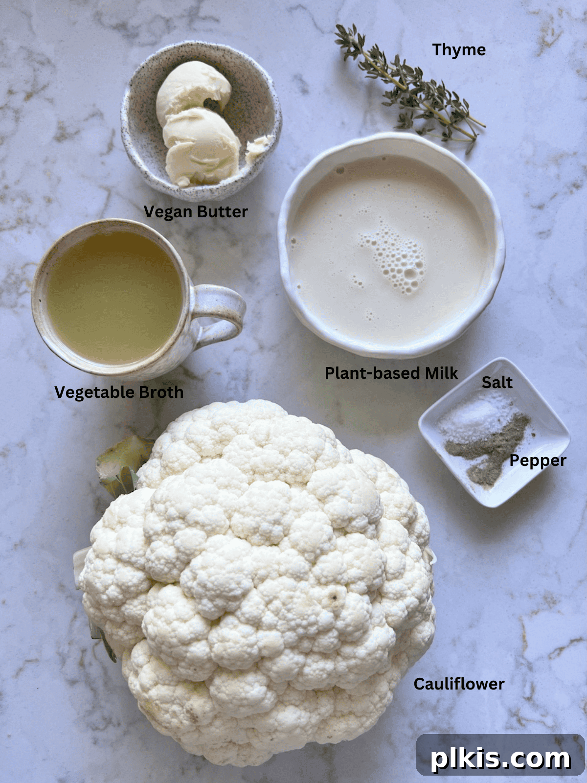 Creamy Vegan Mashed Cauliflower Keto Low Carb 3 ingredients for mashed cauliflower measured out against a white surface