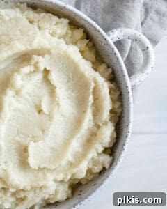 Creamy Vegan Mashed Cauliflower Keto Low Carb 5 completed mashed cauliflower in a white dish against white background
