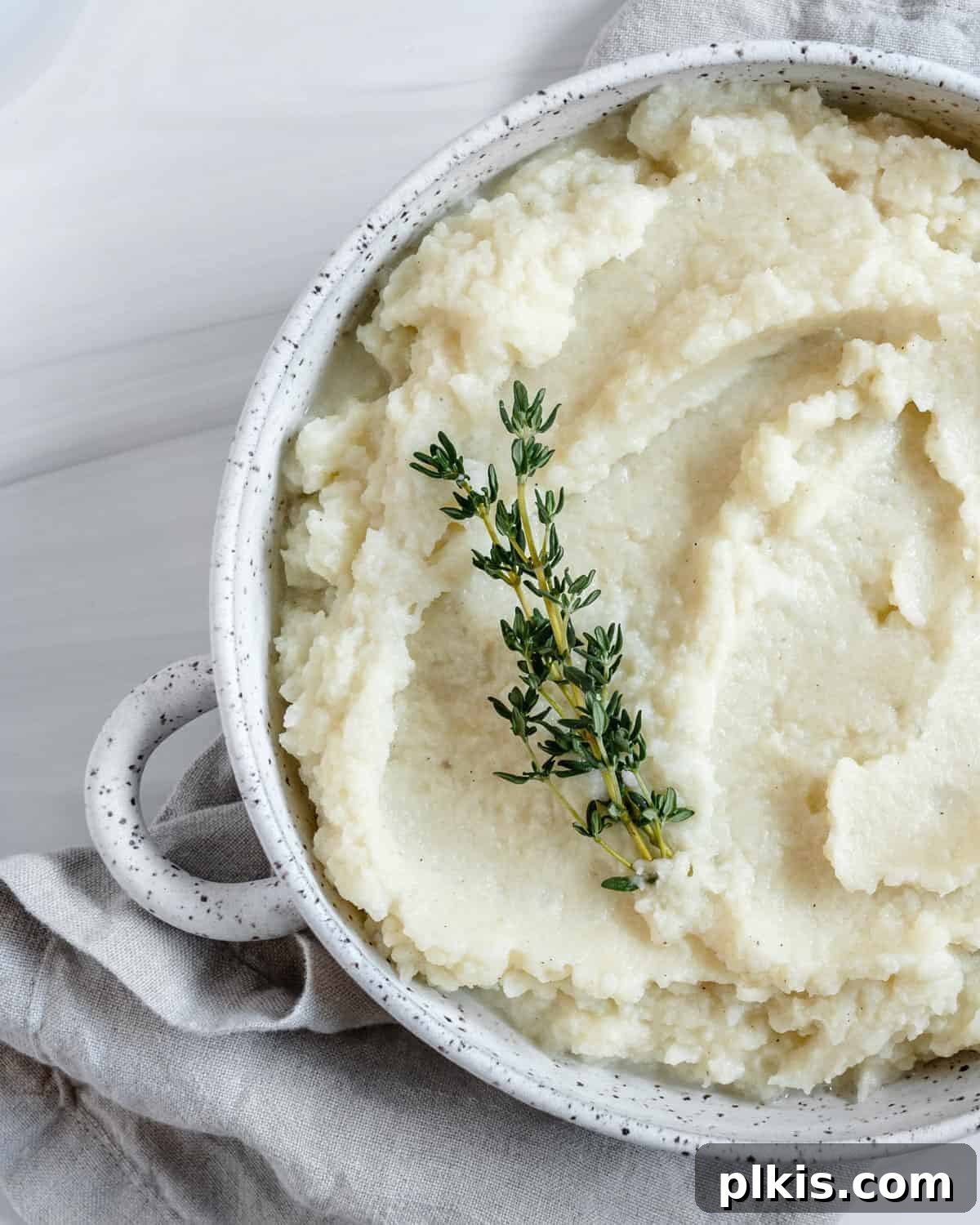 Creamy Vegan Mashed Cauliflower Keto Low Carb 6 completed mashed cauliflower in a white dish against white background