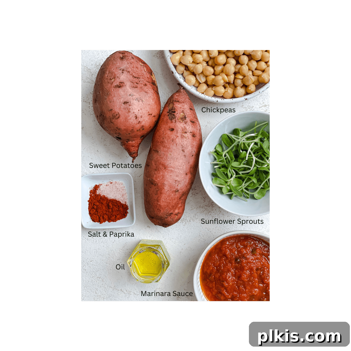 A flat lay photograph showcasing all the raw ingredients needed for Chickpea Sweet Potato Boats: whole sweet potatoes, a can of chickpeas, a jar of marinara sauce, and a bundle of fresh sunflower sprouts.