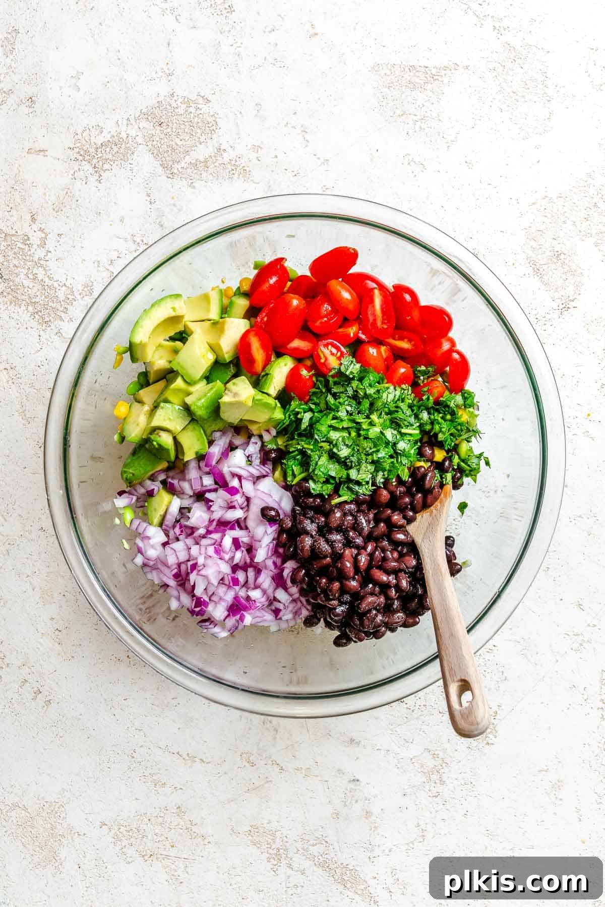 Vibrant Edamame Corn and Black Bean Salad 5 Process shot showing a large bowl with various ingredients for the Edamame Salad mixed together.