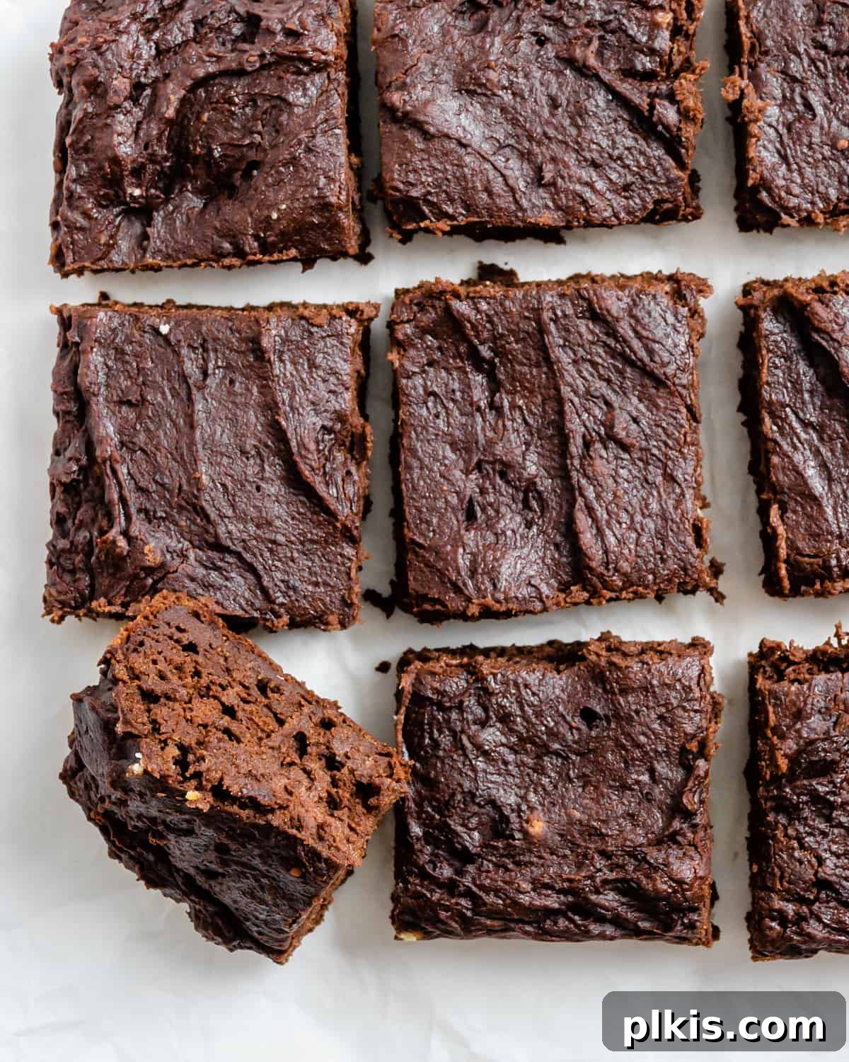 Pumpkin Spice Brownie Perfection 2 completed Easy Pumpkin Brownies against a white surface, showcasing their fudgy texture