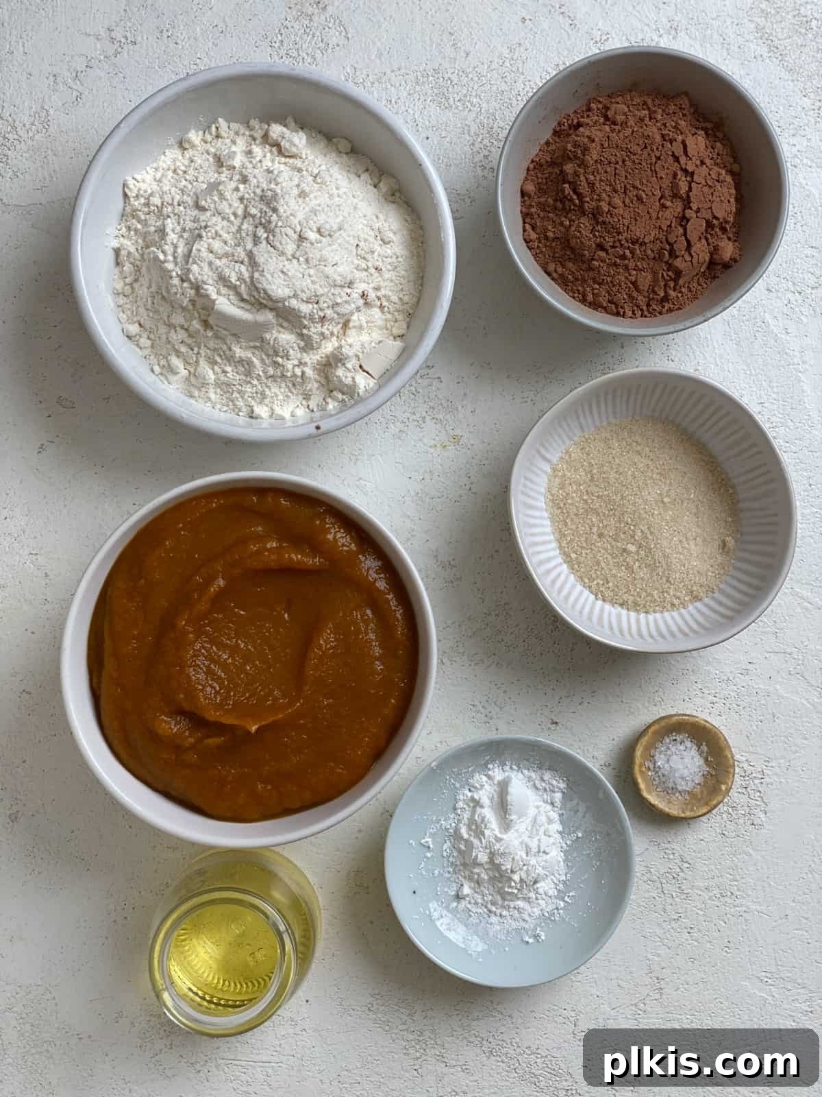 Pumpkin Spice Brownie Perfection 3 ingredients for Easy Pumpkin Brownies against a white surface, clearly laid out