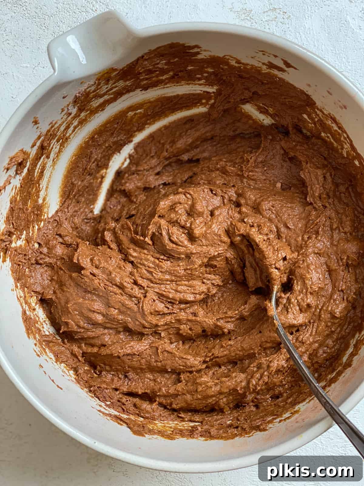 Pumpkin Spice Brownie Perfection 5 process shot of mixing Easy Pumpkin Brownies together in a bowl, showing the smooth batter