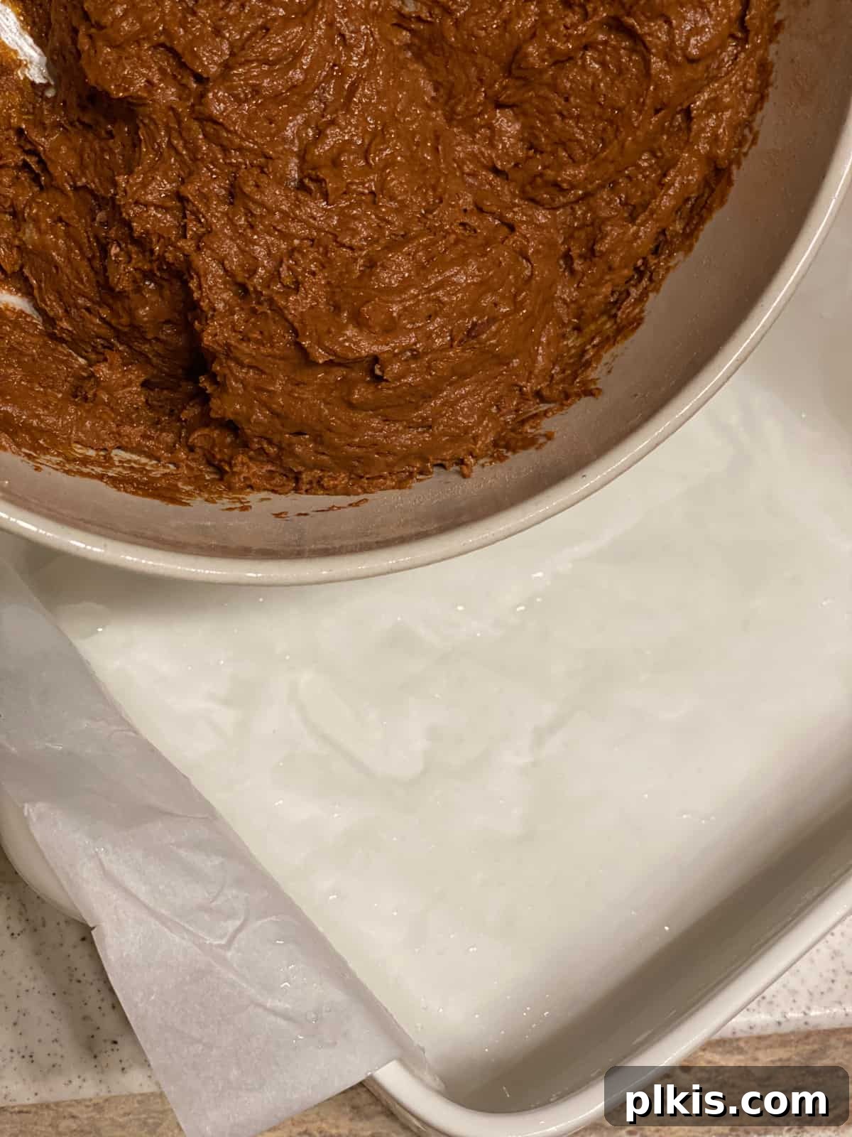 Pumpkin Spice Brownie Perfection 6 process shot of pouring brownie batter into baking pan, showing a smooth even layer