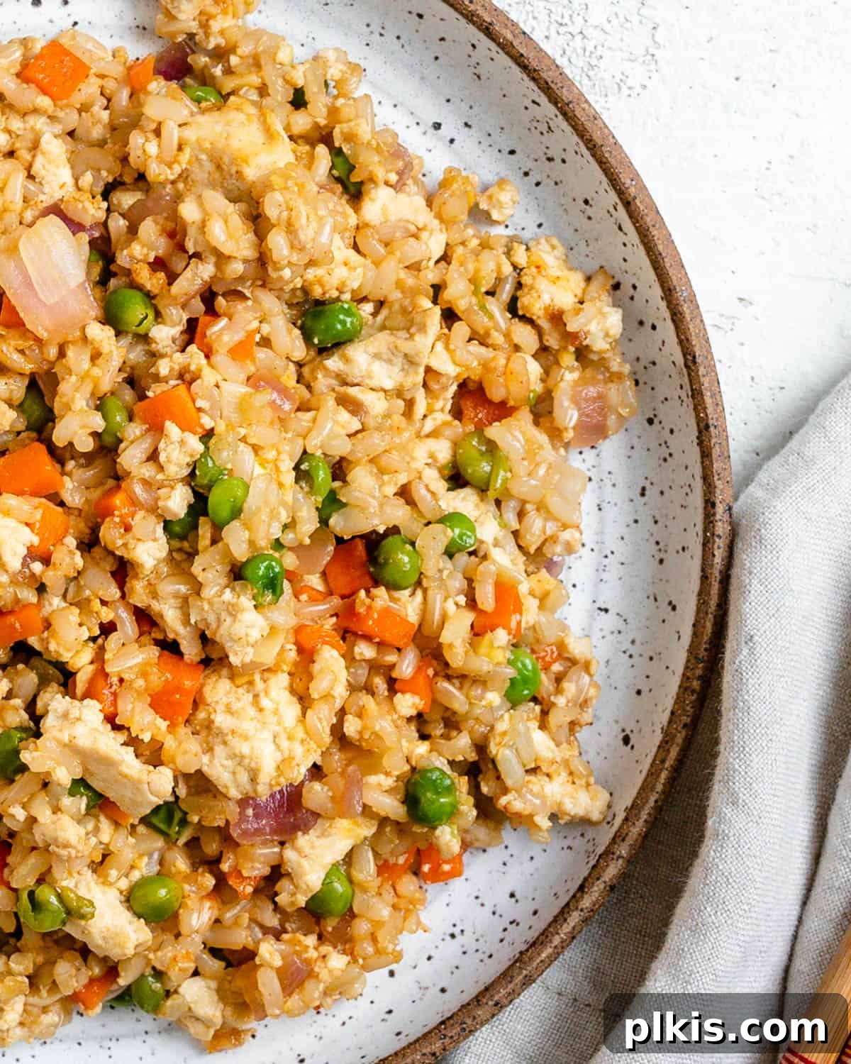 Quick Veggie Brown Rice Stir-Fry 2 completed Easy Vegetable Brown Fried Rice plated on a white plate against a light background
