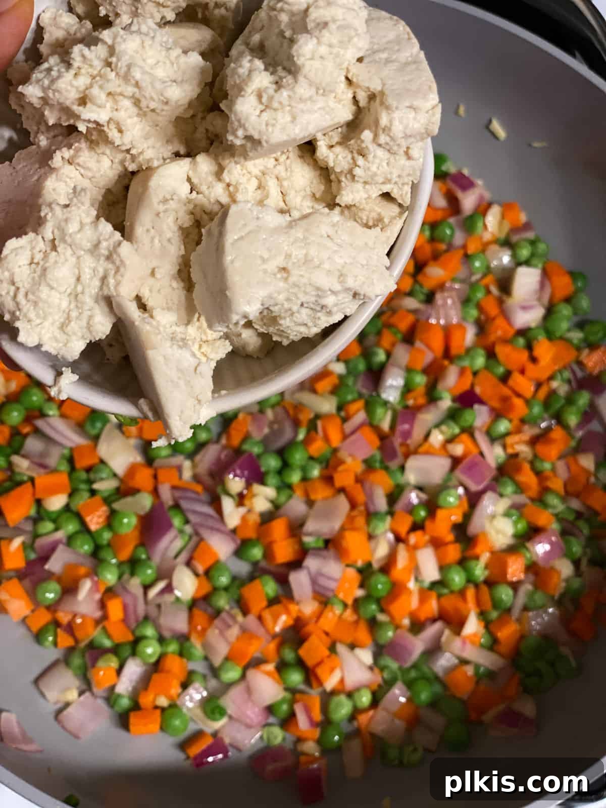 Quick Veggie Brown Rice Stir-Fry 5 process shot of adding tofu to pan