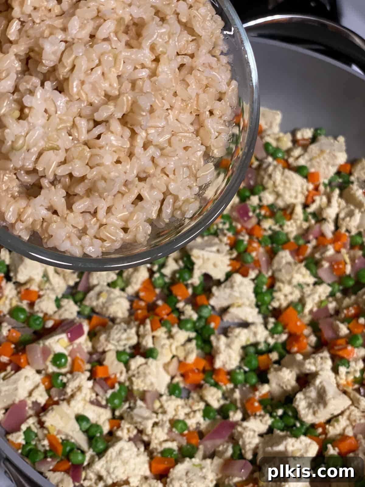 Quick Veggie Brown Rice Stir-Fry 6 process shot of adding rice to pan